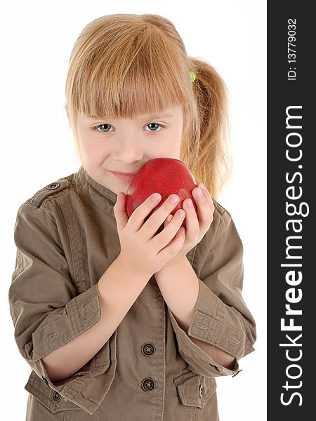 Friendly girl in walking clothing holds apple. Friendly girl in walking clothing holds apple