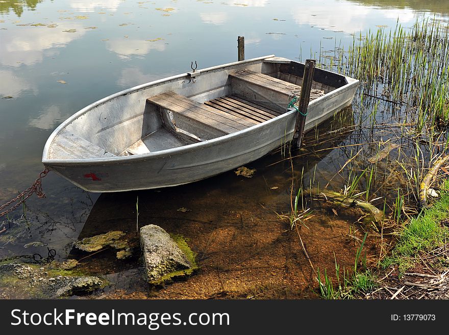 Lonely boat floating on the lake. Lonely boat floating on the lake