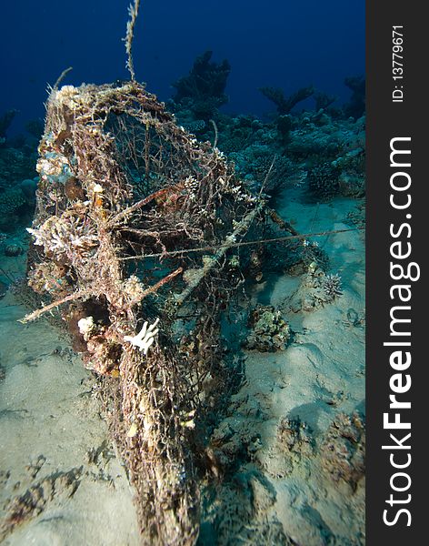 Broken fishing equipment discarded on top off a coral reef. Broken fishing equipment discarded on top off a coral reef.