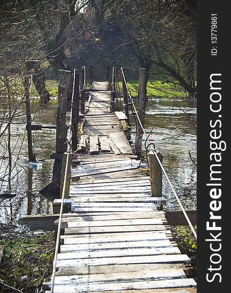 An old pendulous bridge connecting river shores