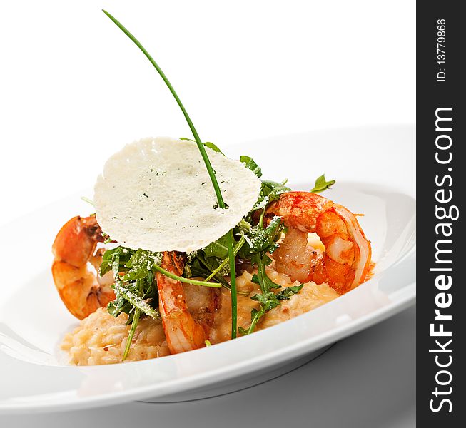 Risotto with Tiger Prawns and Rucola. Served with Parmesan Chip. Risotto with Tiger Prawns and Rucola. Served with Parmesan Chip