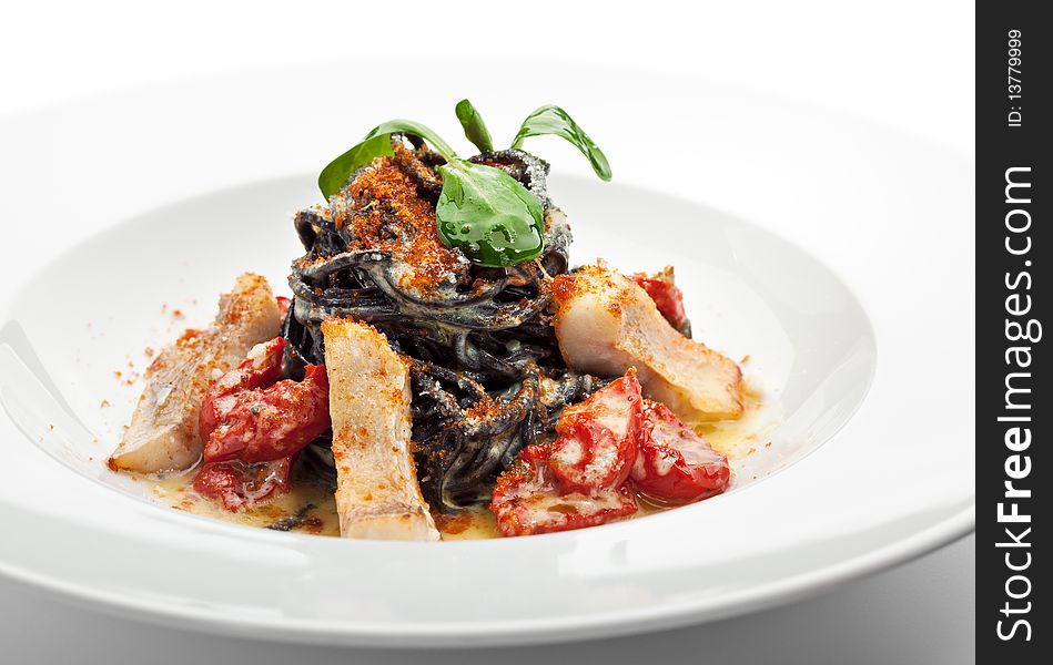 Black Spaghetti with Sea Bass and Batarga (dried, salted, pressed red roe) and Dried Cherry Tomato. Served with Fresh Corn Salad Leaves