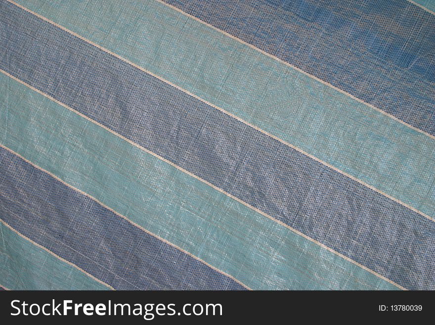 Striped blue and white background on a plastic sheet