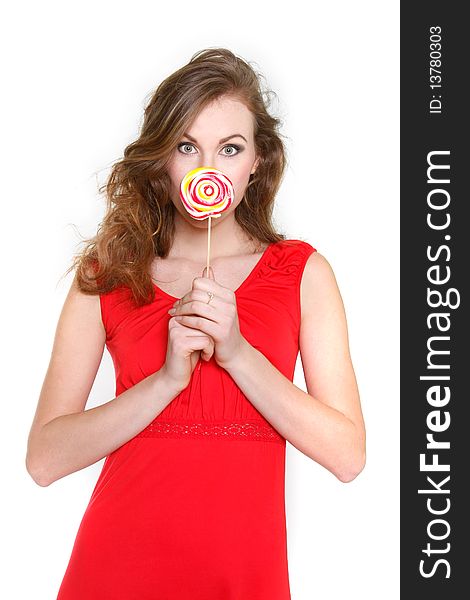 Portrait of attractive young woman with big lollipop over white