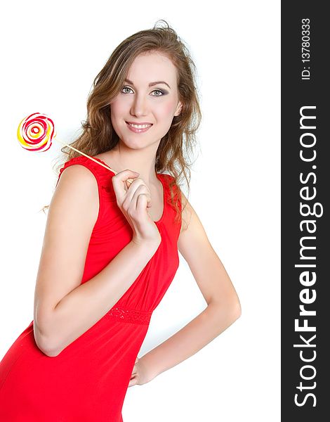 Smiling young woman with big lollipop over white