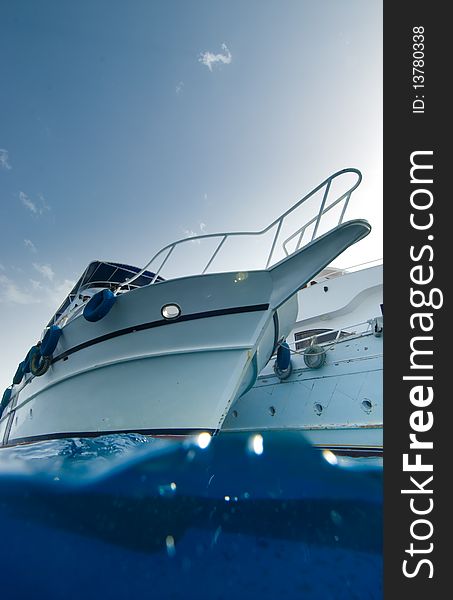 Low angle split view of the bow of a wooden dive boat. Low angle split view of the bow of a wooden dive boat.