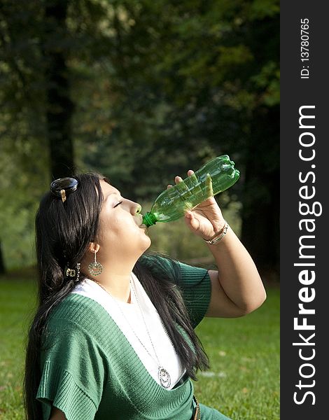 Young beauty woman drinking water at outdoors. Young beauty woman drinking water at outdoors