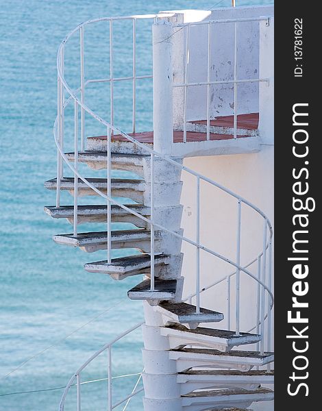 Spiral staircase on ocean background