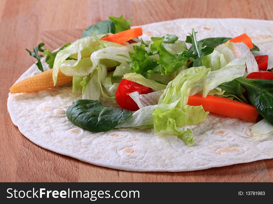 Fresh vegetable salad on tortilla