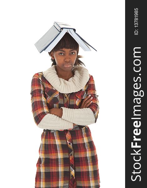 Young black female student with crossed arms and book on head. Young black female student with crossed arms and book on head