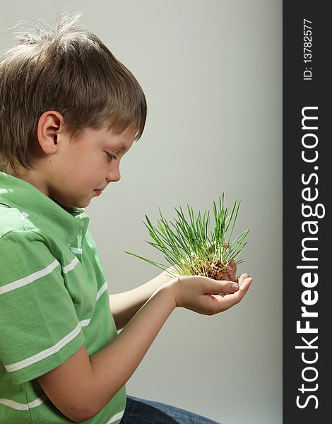 Young boy with sprouts in hands