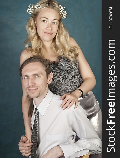 Newlyweds, studio portrait on blue background
