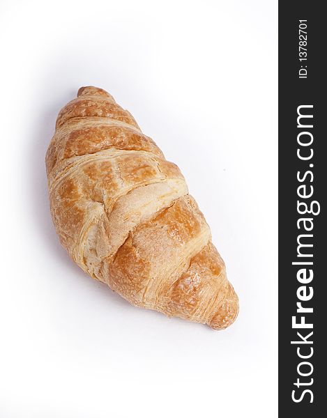 Single fresh croissant, studio isolated