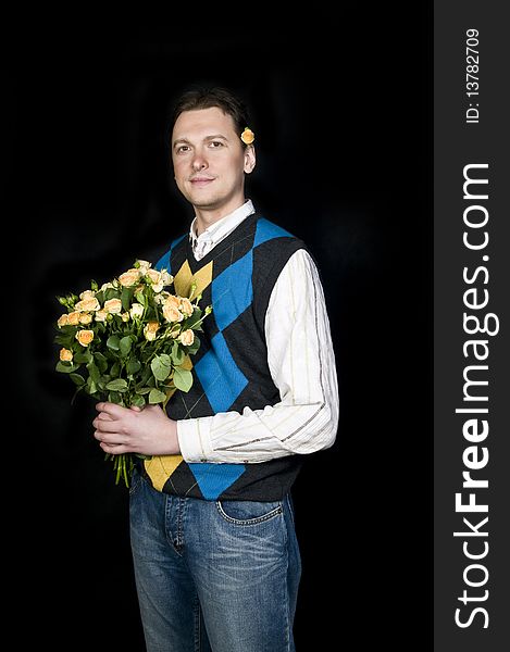A young, attractive and happy man with flowers