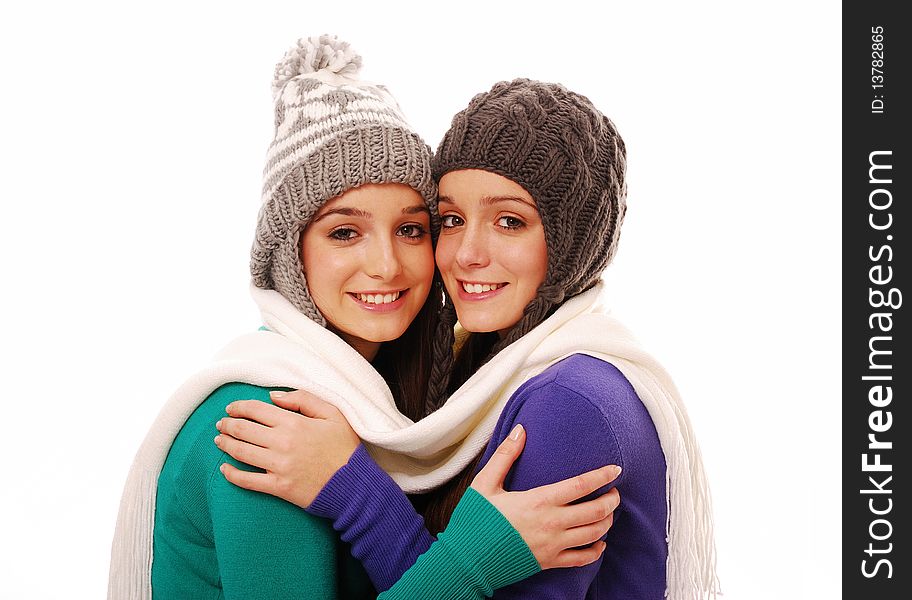 Young teenage girls dressed in winter clothing isolated on white. Young teenage girls dressed in winter clothing isolated on white