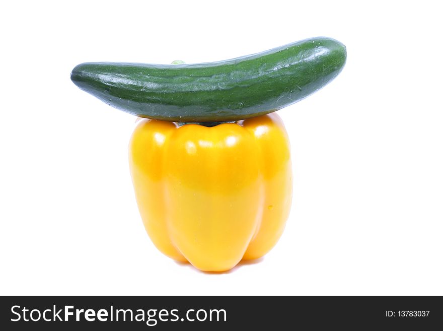 Pepper with cucumber over white background