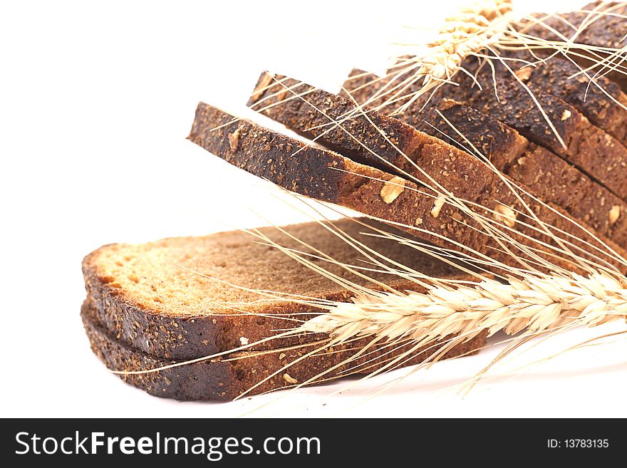 Wheat and bread over white background