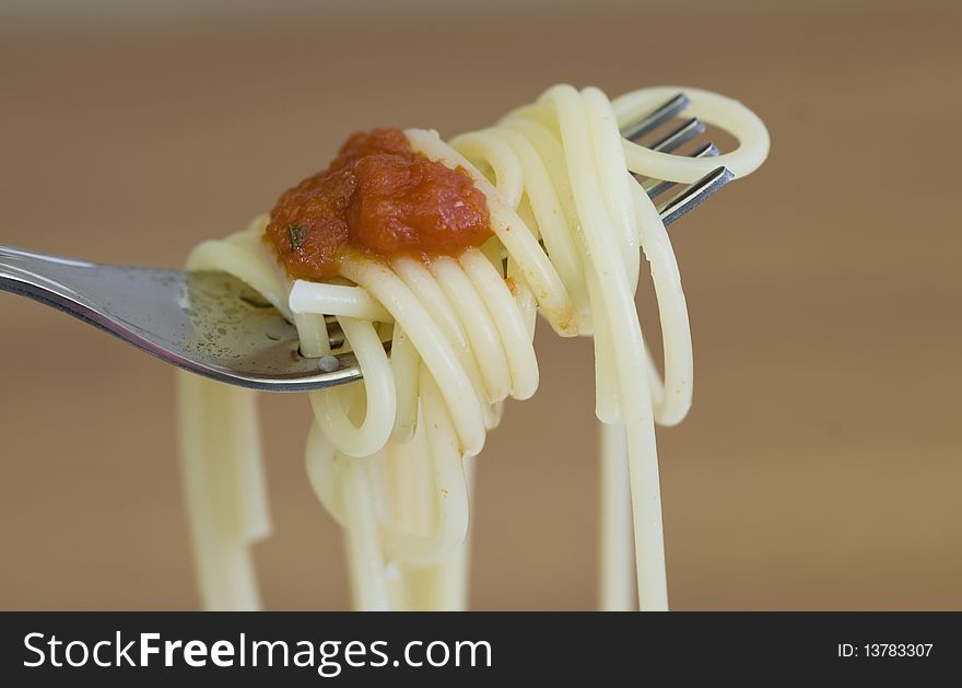 Freshly made spaghetti rolled on fork. Freshly made spaghetti rolled on fork