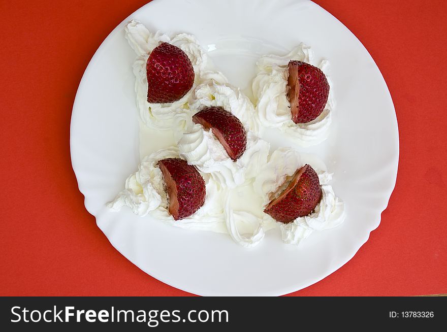Fresh strawberries and light cream, on red background. Fresh strawberries and light cream, on red background