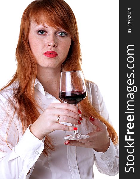 Portrait of a beautiful redhead girl with a glass of red wine