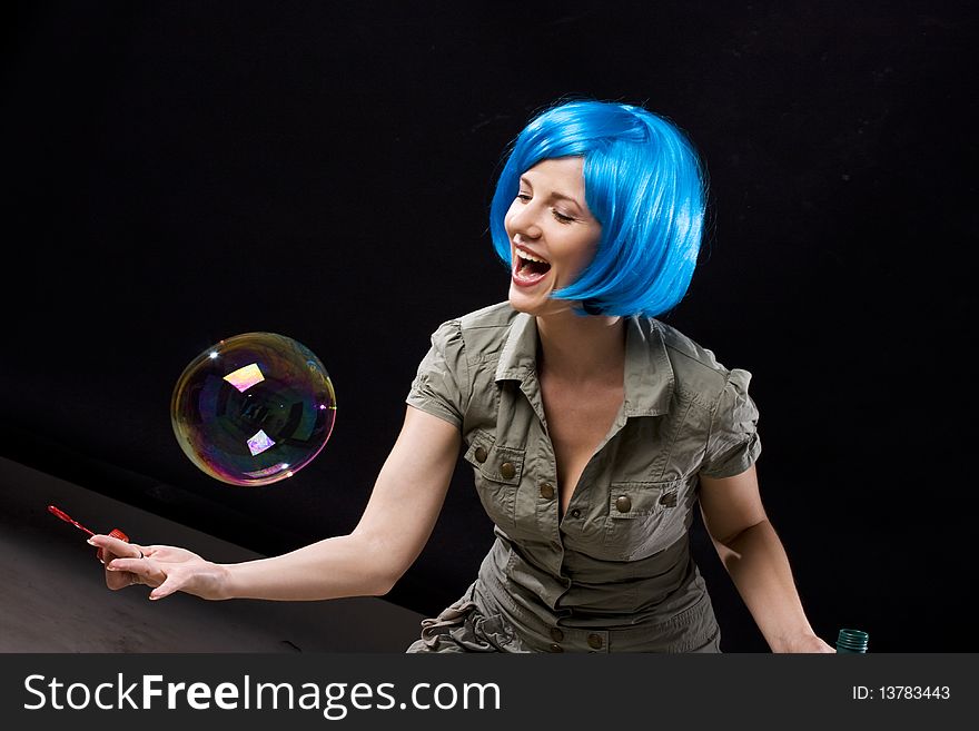 Woman in blue wig with soap bubbles. Woman in blue wig with soap bubbles