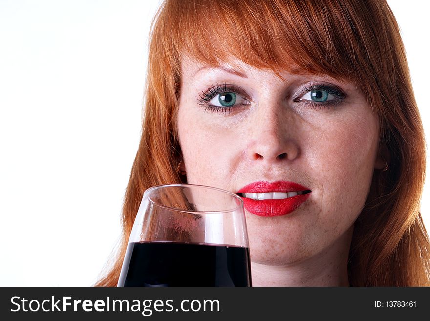 Beautiful redhead girl with a glass of red wine