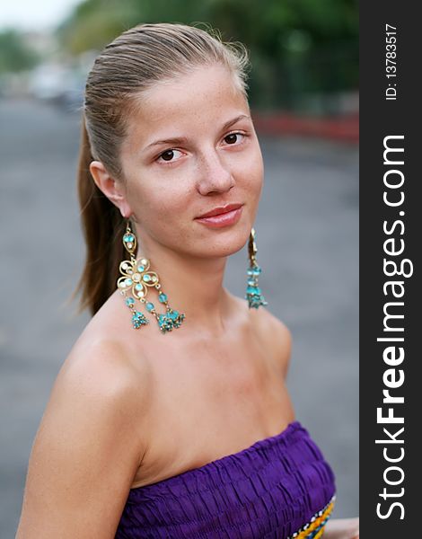Portrait young woman with long beautiful earrings. Portrait young woman with long beautiful earrings