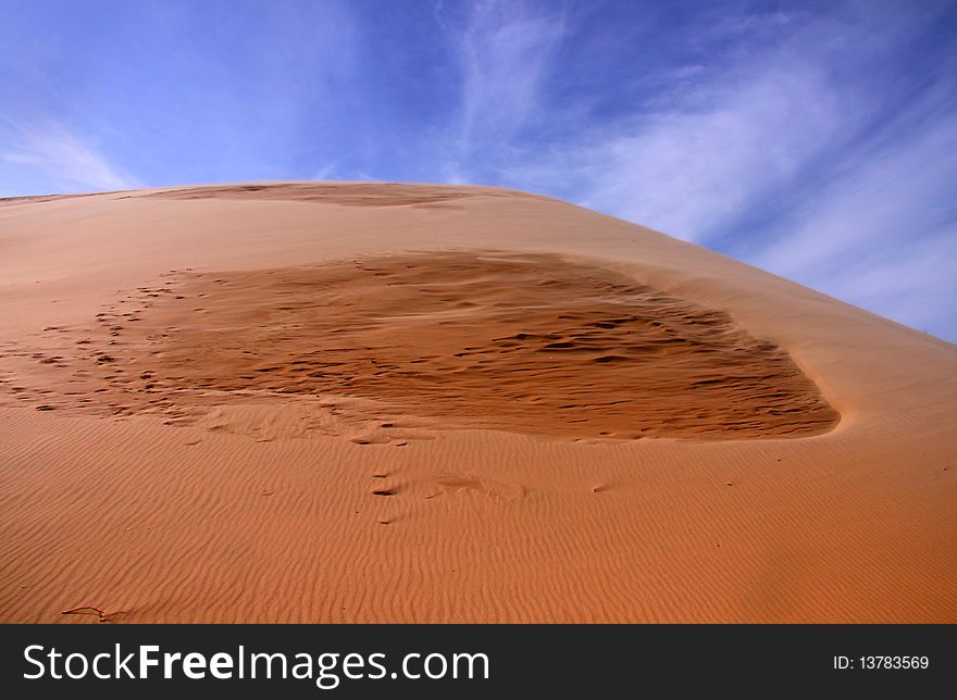 Scenic sand dunes against blue sky background