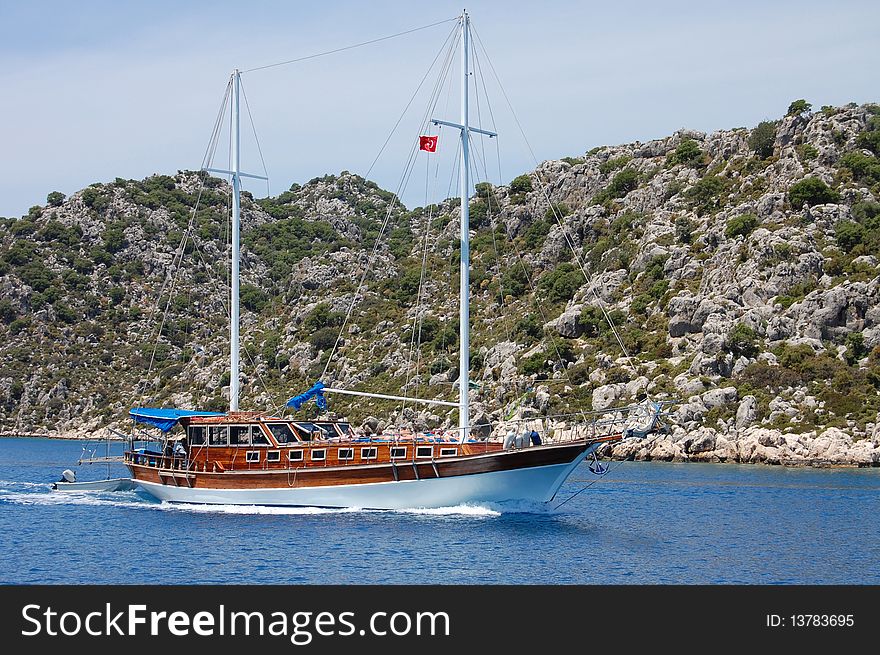 Yacht sea stones decks mast, flag, Turkish, Turkey, Mediterranean,. Yacht sea stones decks mast, flag, Turkish, Turkey, Mediterranean,