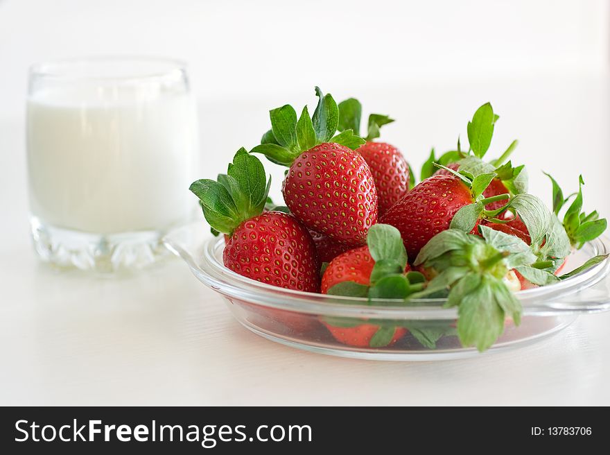 Fresh strawberries and a glass of milk. Fresh strawberries and a glass of milk