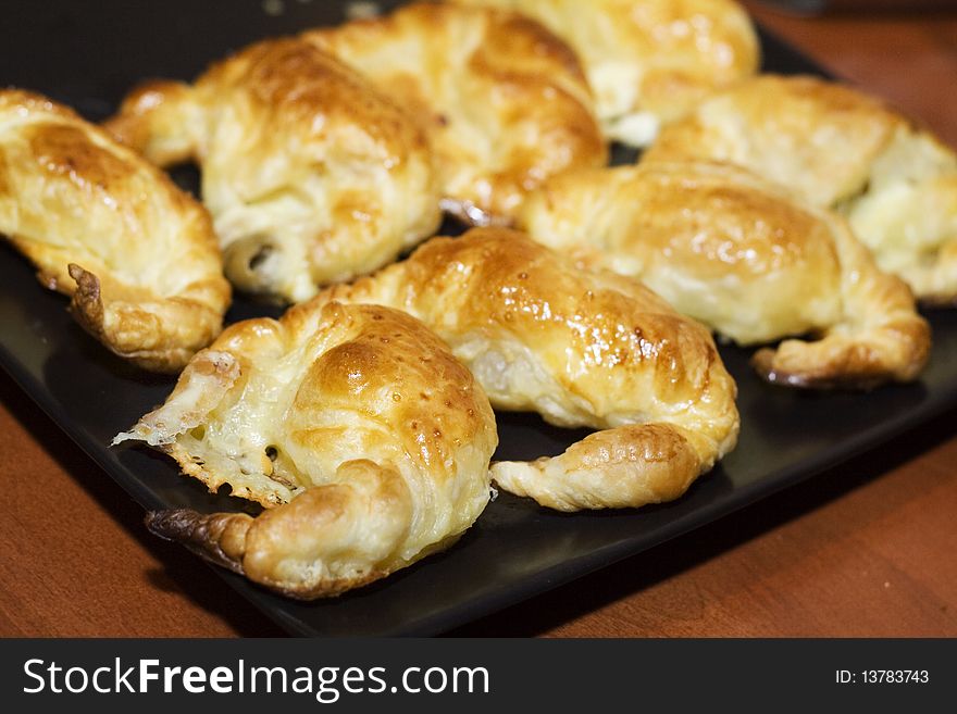 French croissant on black tray