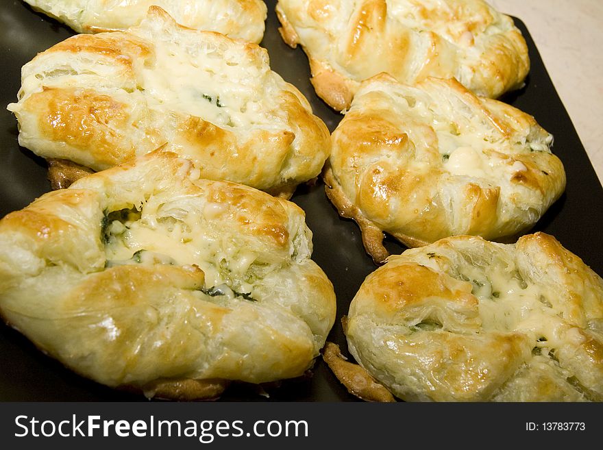 French croissant with spinach on black tray