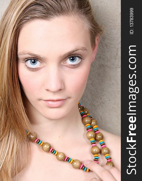 Young female model wearing a colourful beadwork necklace. Young female model wearing a colourful beadwork necklace