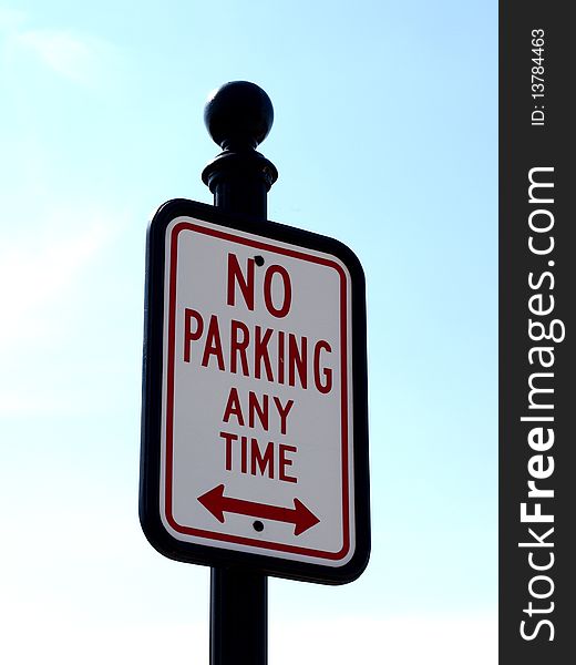 No parking any time sign on blue sky