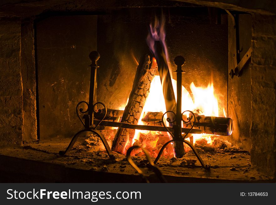 A set of logs burning inside a fireplace gives a warm feeling. A set of logs burning inside a fireplace gives a warm feeling