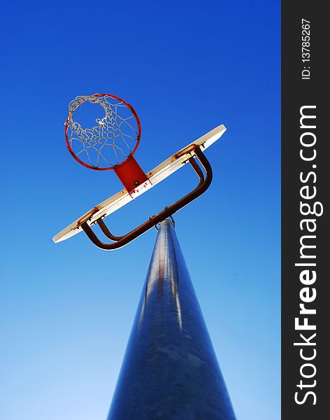 Basketball hoop with blue sky in the background