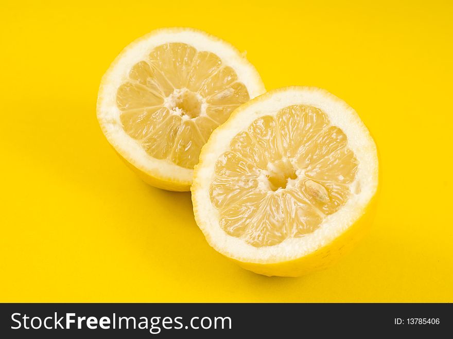 Two half lemon on yellow background