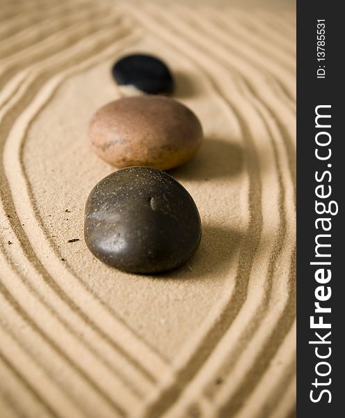 Three stones on brown sand