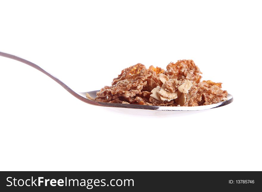 Cereal on a spoon over white background