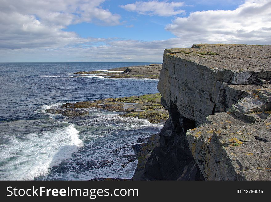 A rocky coastline is washed by the waves