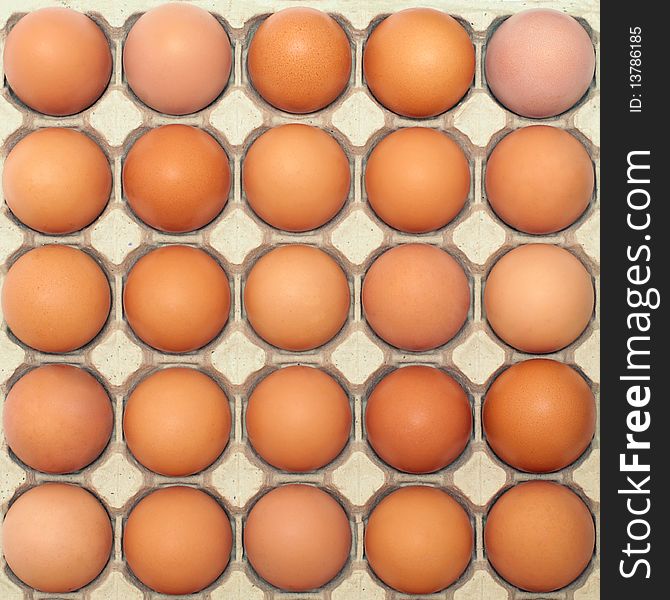 Background of brown eggs in a protective container