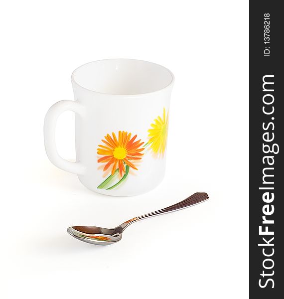 Mug and spoon on a white background