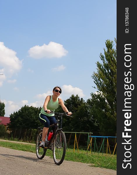 Woman Cycling In A Park