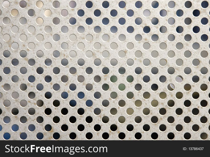 Bright brushed and drilled a hole metal texture background