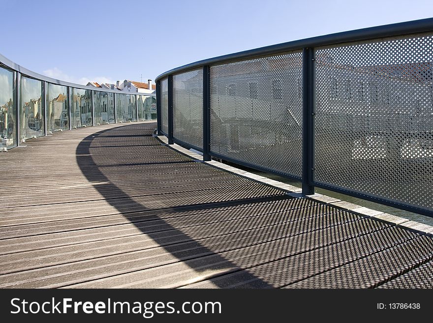 Wooden bridge and rails. A pathway into a urbanscape. Wooden bridge and rails. A pathway into a urbanscape