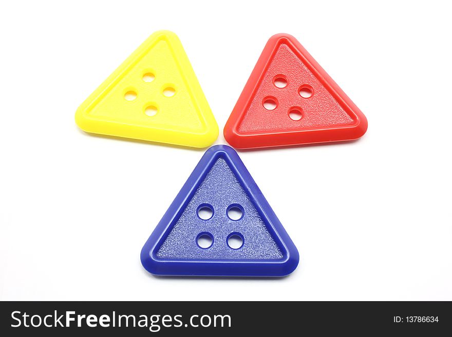 Three triangle buttons that are yellow, red, and blue together in a design.