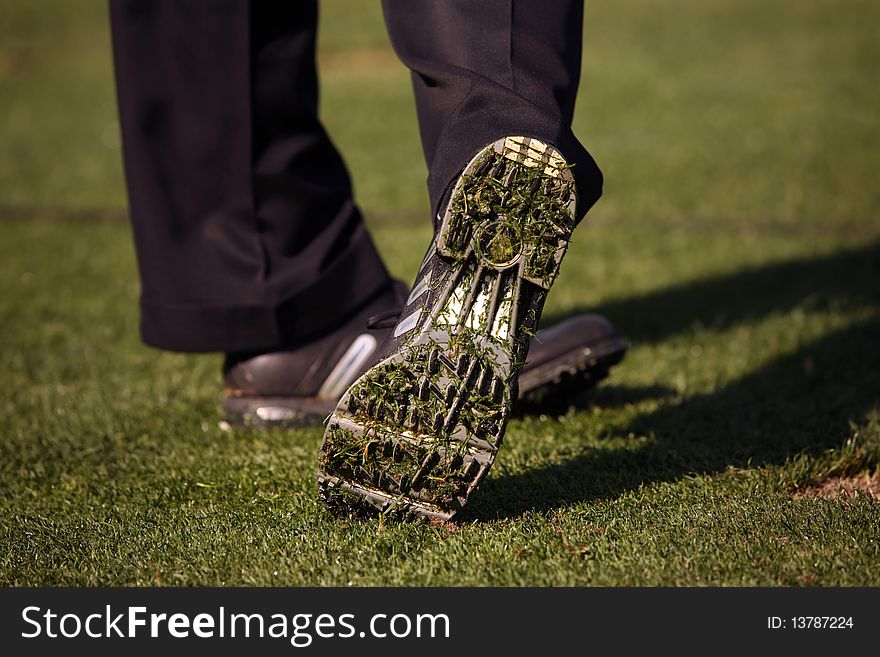 Close-up Of Golfer S Shoe After Hitting Ball