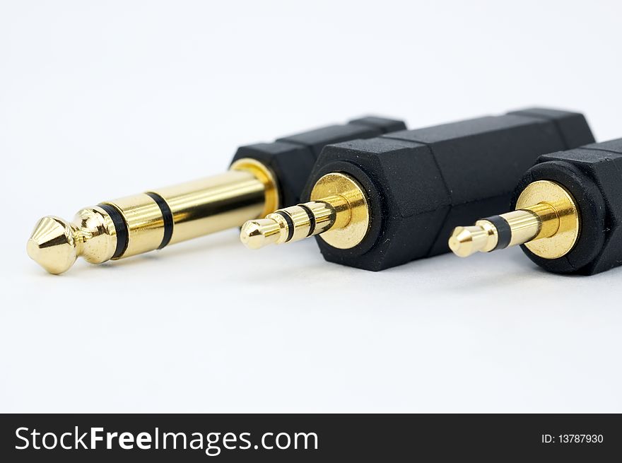 Variety of audio connectors against white background. Variety of audio connectors against white background