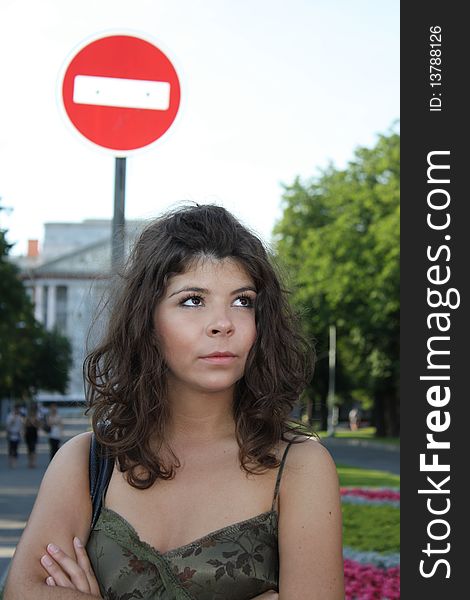 Girl looking up near the road sign in St-Petersburg