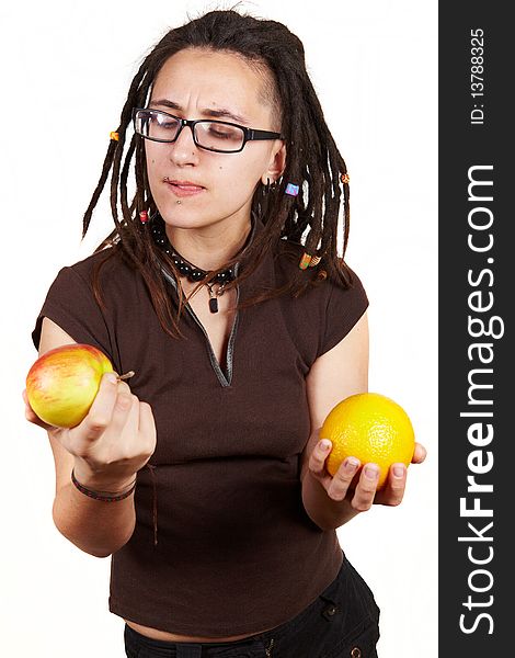 Girl with dreadlocks choise between apple and orange. Girl with dreadlocks choise between apple and orange